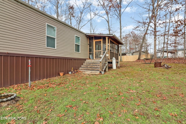 exterior space featuring a sunroom and a front lawn