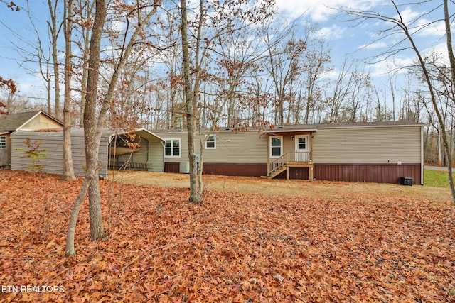 back of property with a carport