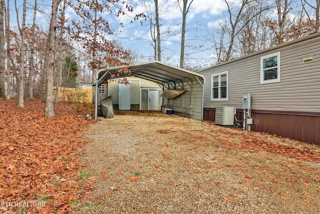 view of home's exterior with central AC and a carport