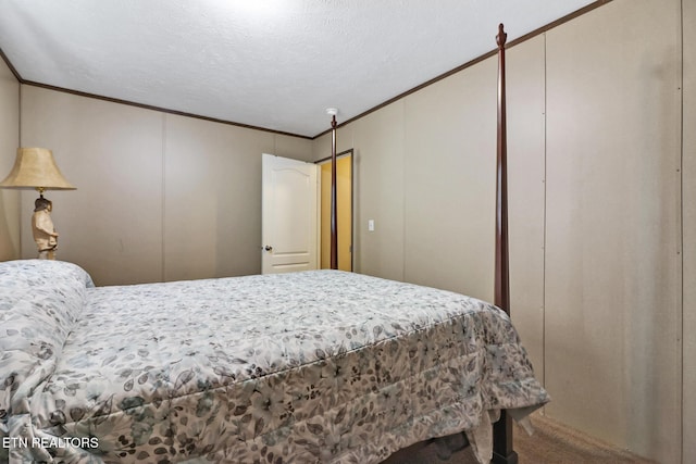 bedroom featuring a textured ceiling and ornamental molding