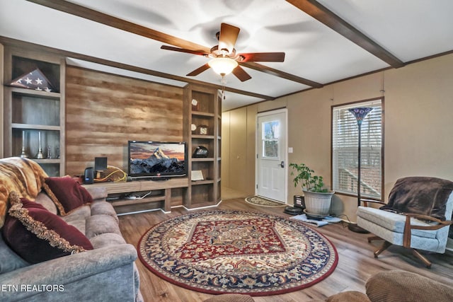 living room featuring beam ceiling, ceiling fan, and hardwood / wood-style flooring