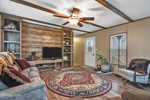 living room with beam ceiling, ceiling fan, and wood-type flooring