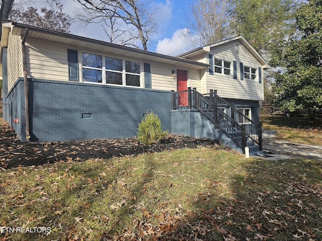 tri-level home featuring brick siding and crawl space