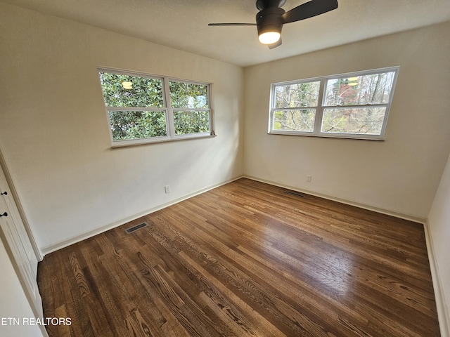 empty room featuring dark hardwood / wood-style flooring and ceiling fan