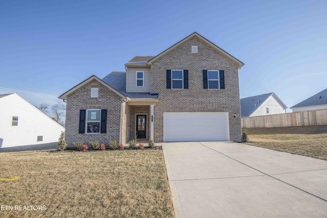 view of property featuring a garage and a front lawn