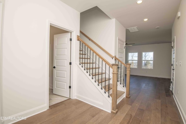 staircase with hardwood / wood-style flooring