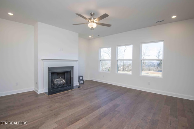 unfurnished living room with dark wood-type flooring and ceiling fan