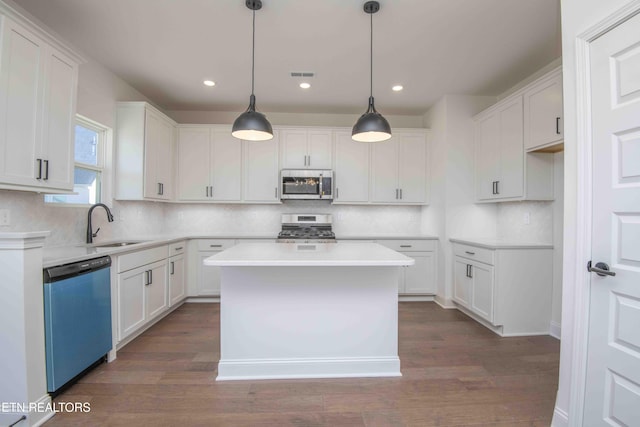 kitchen with white cabinets and appliances with stainless steel finishes