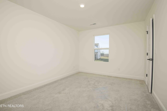 spare room with light colored carpet