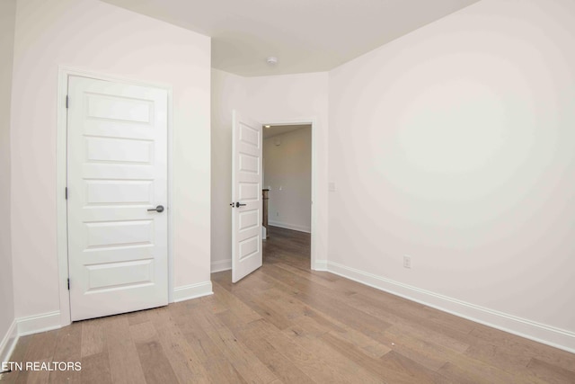 unfurnished bedroom with light wood-type flooring