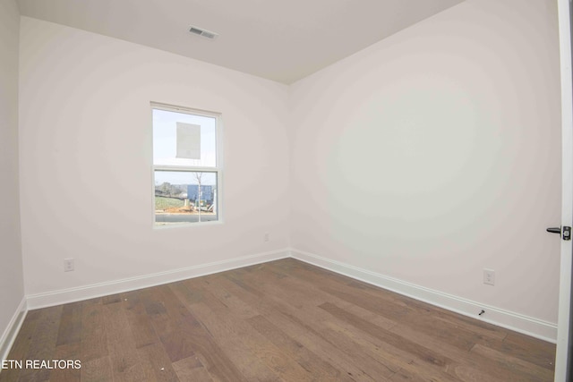 empty room with dark wood-type flooring