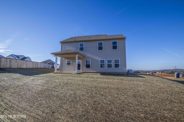 rear view of house with a lawn