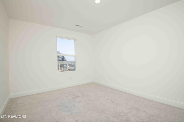 unfurnished room with light carpet