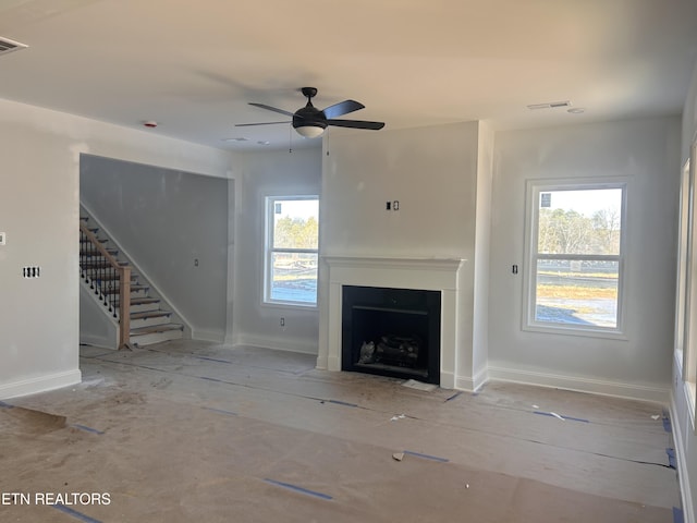 unfurnished living room with ceiling fan