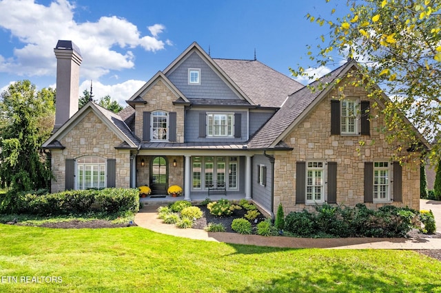 view of front of property with a porch and a front lawn