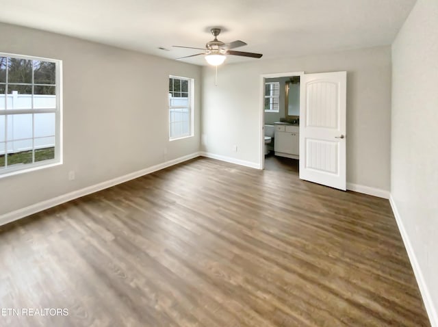 empty room with dark hardwood / wood-style flooring and ceiling fan