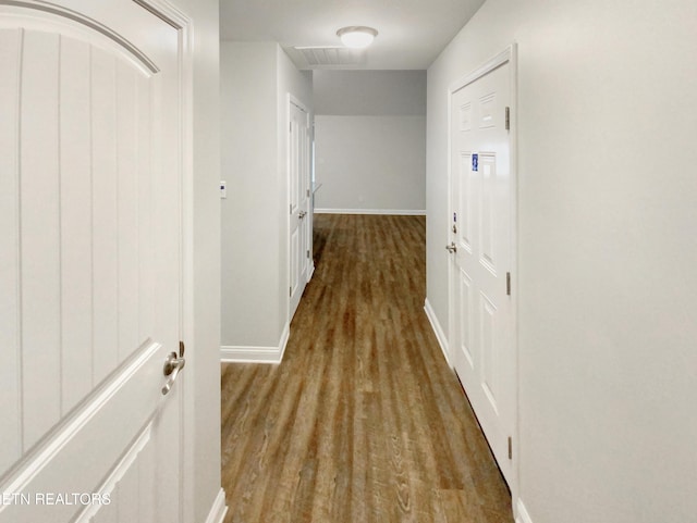 hallway with light hardwood / wood-style floors