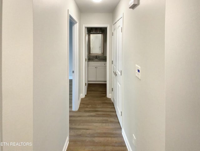 corridor with sink and dark hardwood / wood-style floors