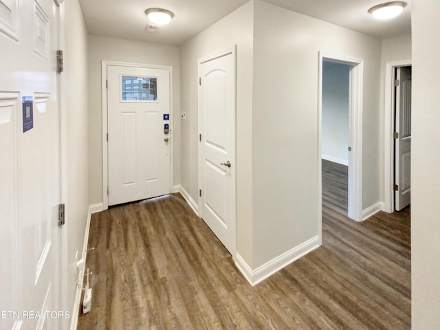 entryway with dark wood-type flooring