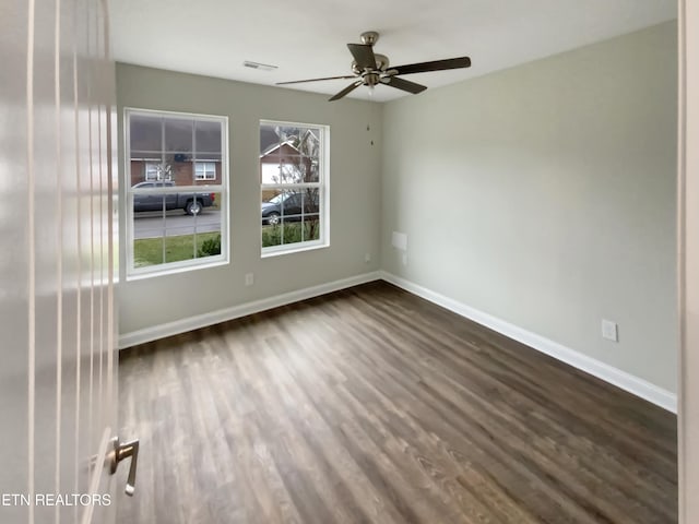 unfurnished room featuring ceiling fan and dark hardwood / wood-style flooring