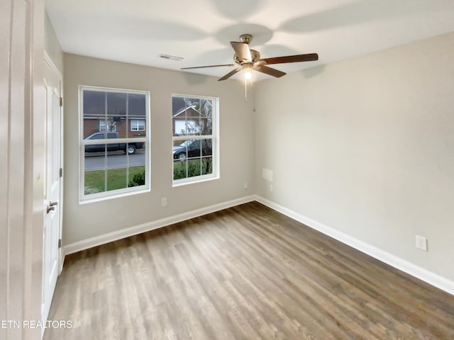 spare room with hardwood / wood-style floors and ceiling fan