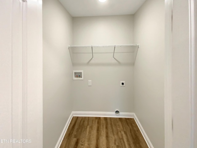 washroom featuring washer hookup, electric dryer hookup, and dark wood-type flooring