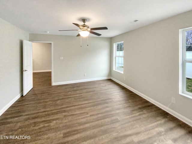 spare room with ceiling fan and dark wood-type flooring