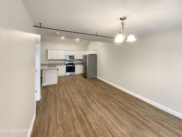 kitchen with sink, a chandelier, decorative light fixtures, white cabinets, and appliances with stainless steel finishes