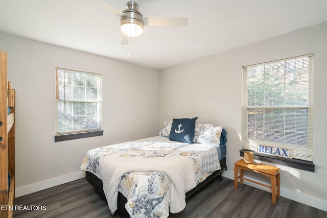 bedroom with multiple windows, dark wood-type flooring, and ceiling fan