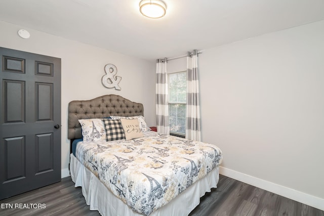 bedroom with dark wood-type flooring