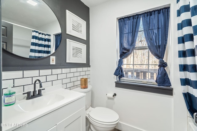 bathroom with decorative backsplash, vanity, and toilet