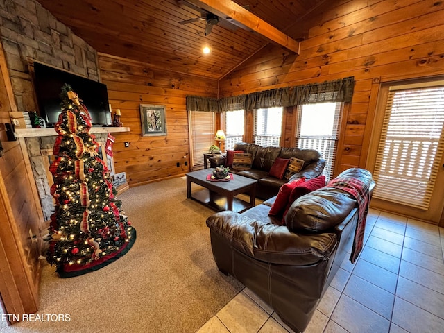 tiled living room with vaulted ceiling with beams, wooden walls, a stone fireplace, and wood ceiling