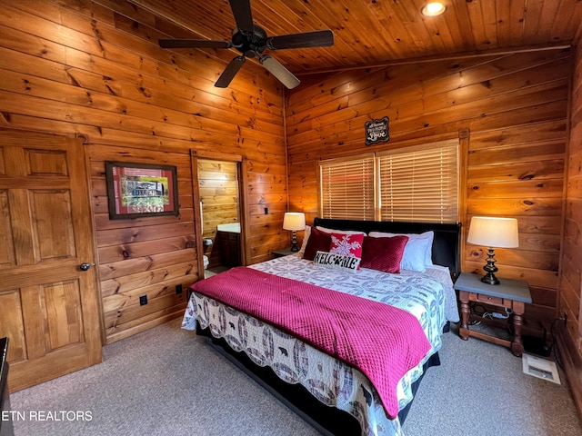 carpeted bedroom with vaulted ceiling, ceiling fan, wooden ceiling, and wood walls