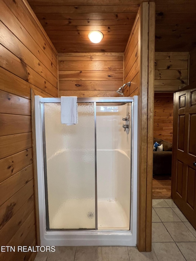 bathroom featuring tile patterned floors, wooden ceiling, walk in shower, and wooden walls