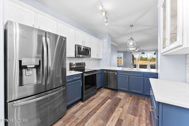 kitchen featuring white cabinetry, blue cabinets, dark wood-type flooring, and appliances with stainless steel finishes