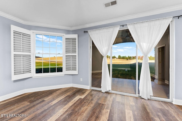 unfurnished room with crown molding, dark wood-type flooring, and a healthy amount of sunlight