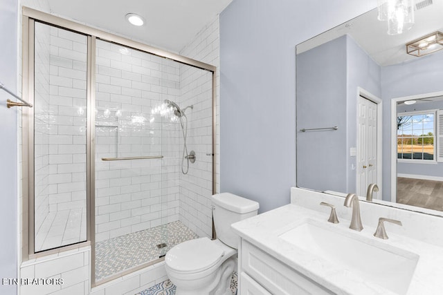 bathroom featuring vanity, toilet, and an enclosed shower