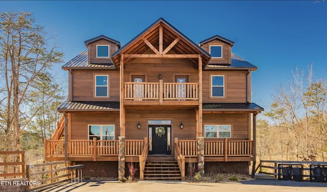 log cabin with a porch and a balcony