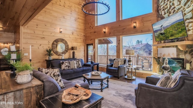 living room with hardwood / wood-style floors, wood walls, wood ceiling, and a high ceiling