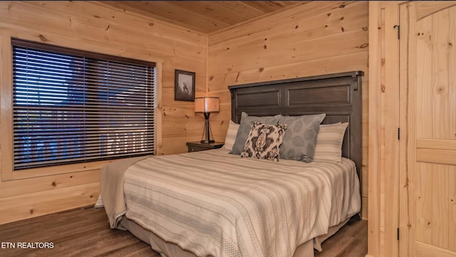 bedroom featuring wood walls, wood ceiling, and dark hardwood / wood-style floors