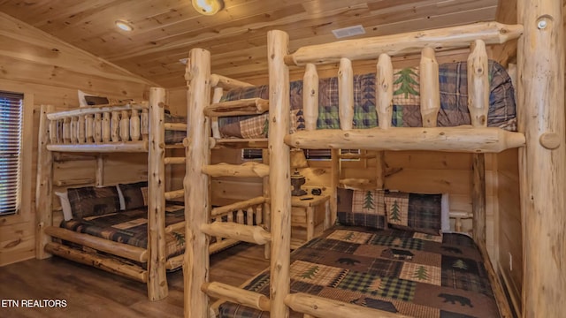 bedroom with hardwood / wood-style flooring, wooden ceiling, and vaulted ceiling