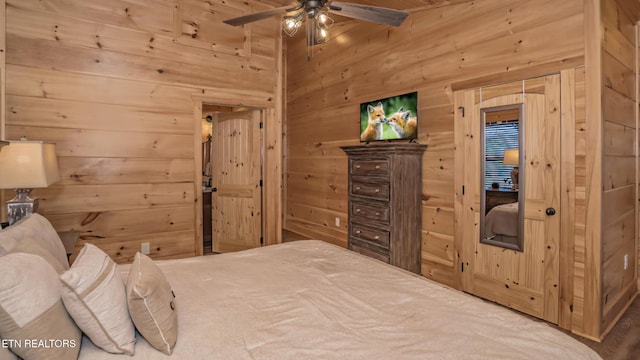 bedroom featuring ceiling fan and wood walls