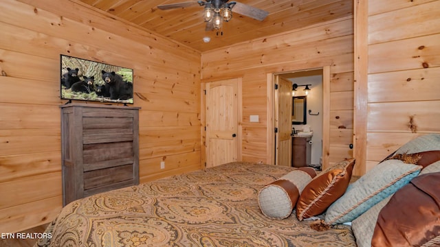 bedroom with ensuite bath, wood walls, ceiling fan, and wooden ceiling