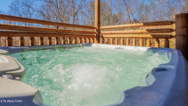 view of swimming pool with a hot tub