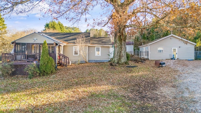 back of house with a sunroom and a deck