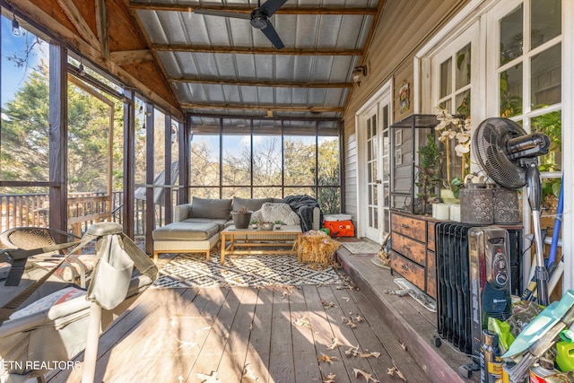 sunroom / solarium featuring vaulted ceiling with beams, ceiling fan, and wooden ceiling