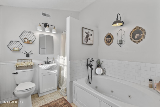 bathroom with vanity, lofted ceiling, tile patterned flooring, toilet, and a tub to relax in