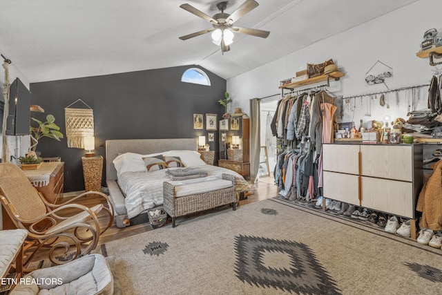 bedroom featuring ceiling fan, lofted ceiling, and hardwood / wood-style flooring