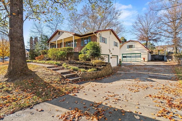 view of side of property with covered porch and a garage