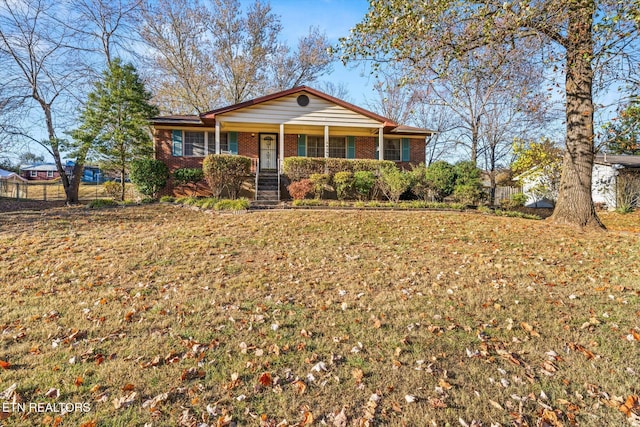 ranch-style house featuring a front lawn and covered porch